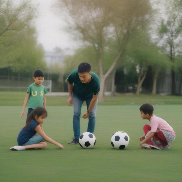 adult supervising kids playing fun football in the park