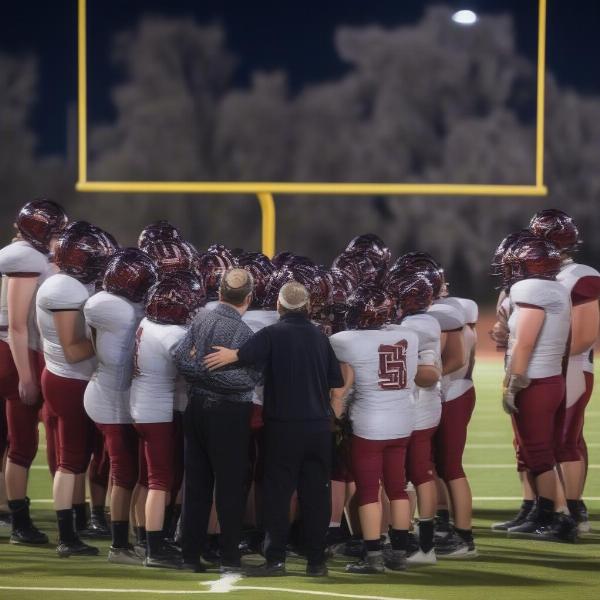 apple valley football team huddle