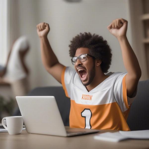 Excited fan watching college football online