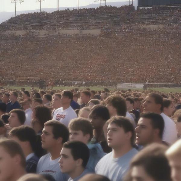 crowd at high school football game with worried faces