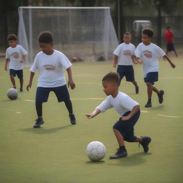 Don Bosco young players working on soccer skills and ball control during practice