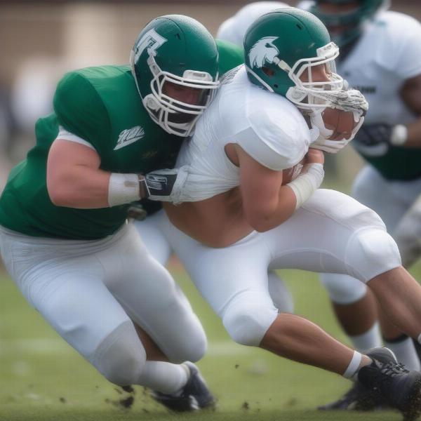 eastern michigan football player tackles opponent