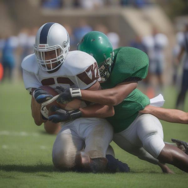 High school football players in tackling action