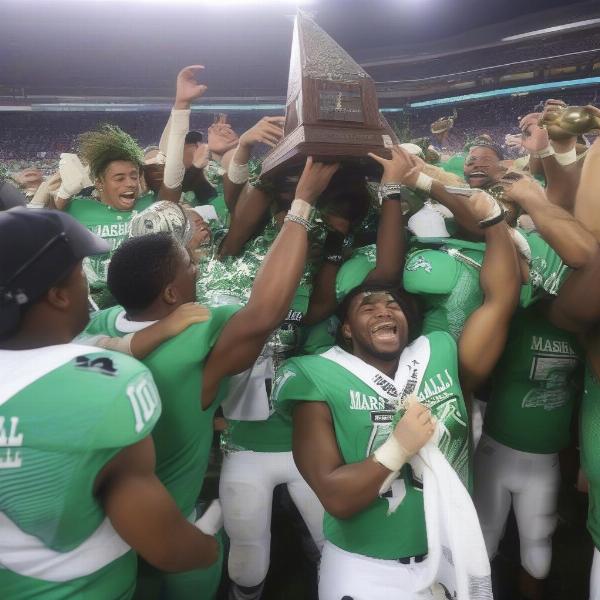 Marshall players celebrate with their bowl game trophy