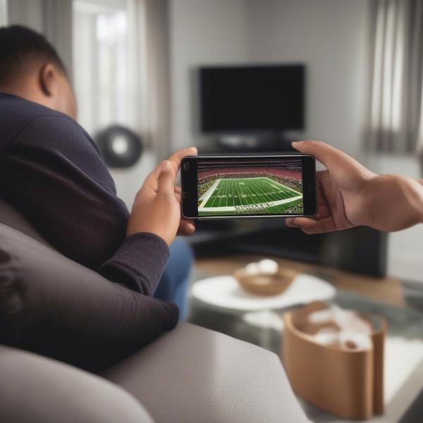 nfl game being viewed on a mobile phone