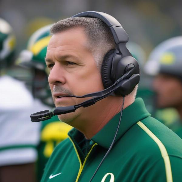 Oregon football coach on the sidelines during a game