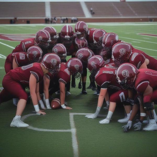 Owasso Rams football team huddle, players with helmets, intense focus