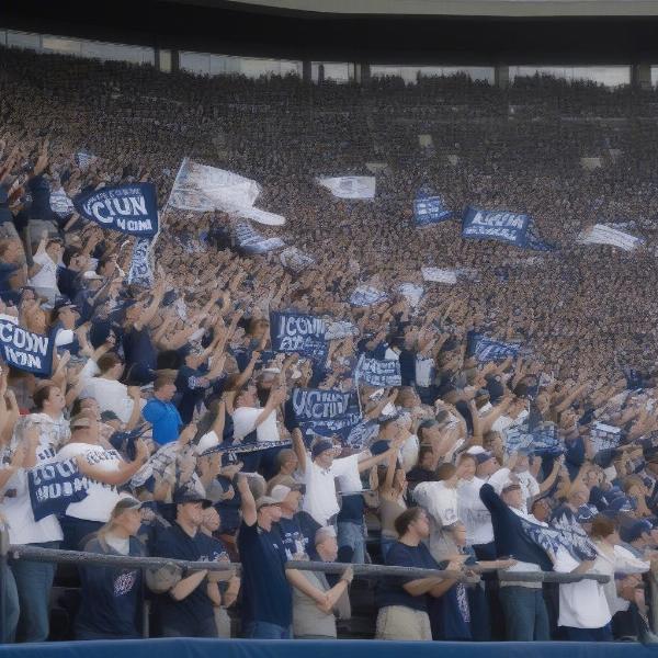 uconn football fans cheering enthusiastically during game