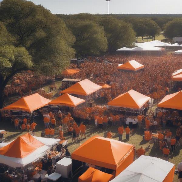 ut austin football game tailgate setup with burnt orange tents and grilling