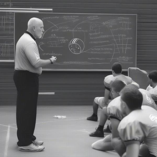 vt-coach-explaining-strategy-on-chalkboard