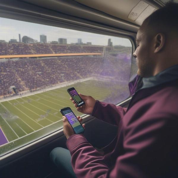 man watching vikings game on phone